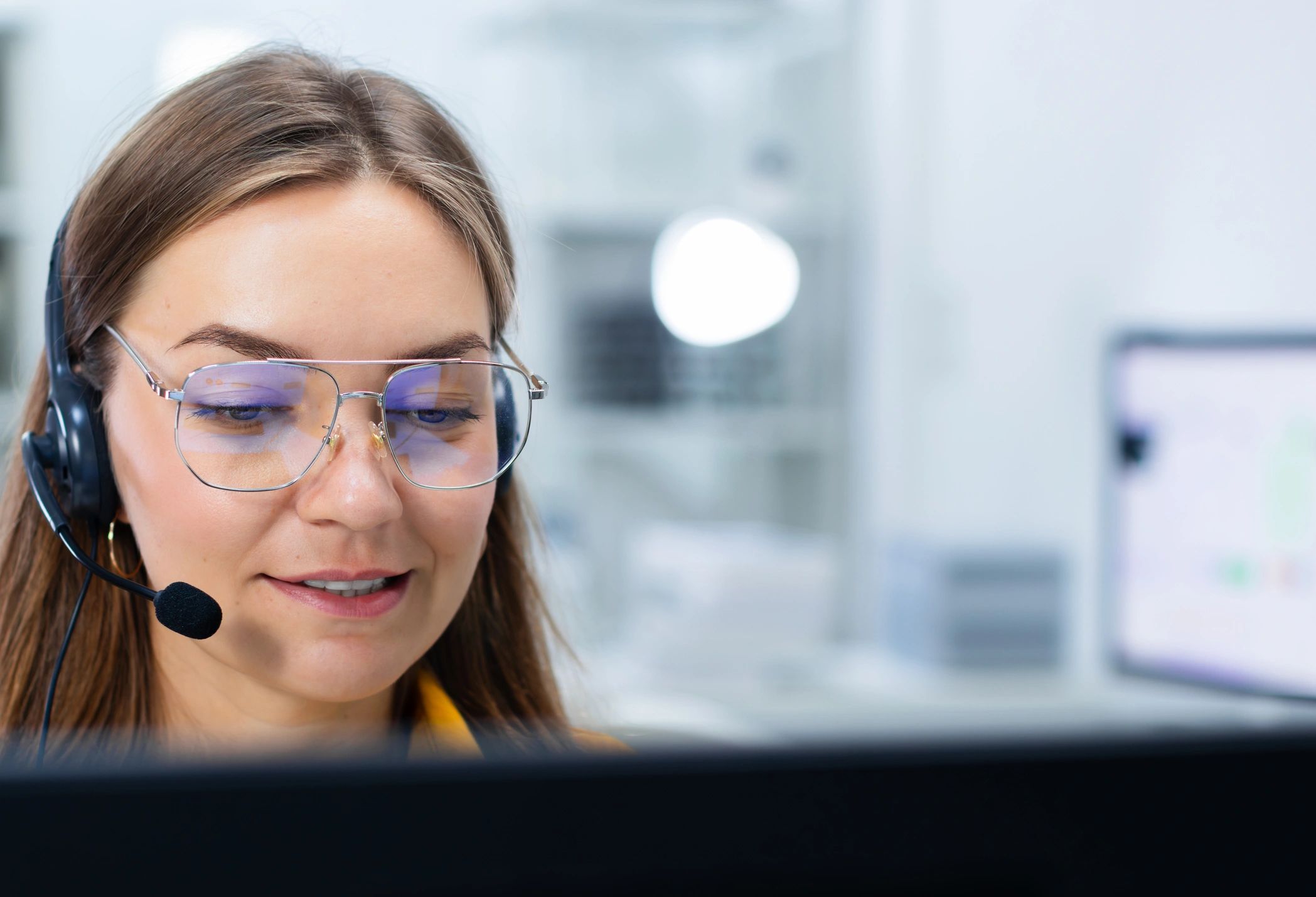 Support specialist at a computer wearing a headset